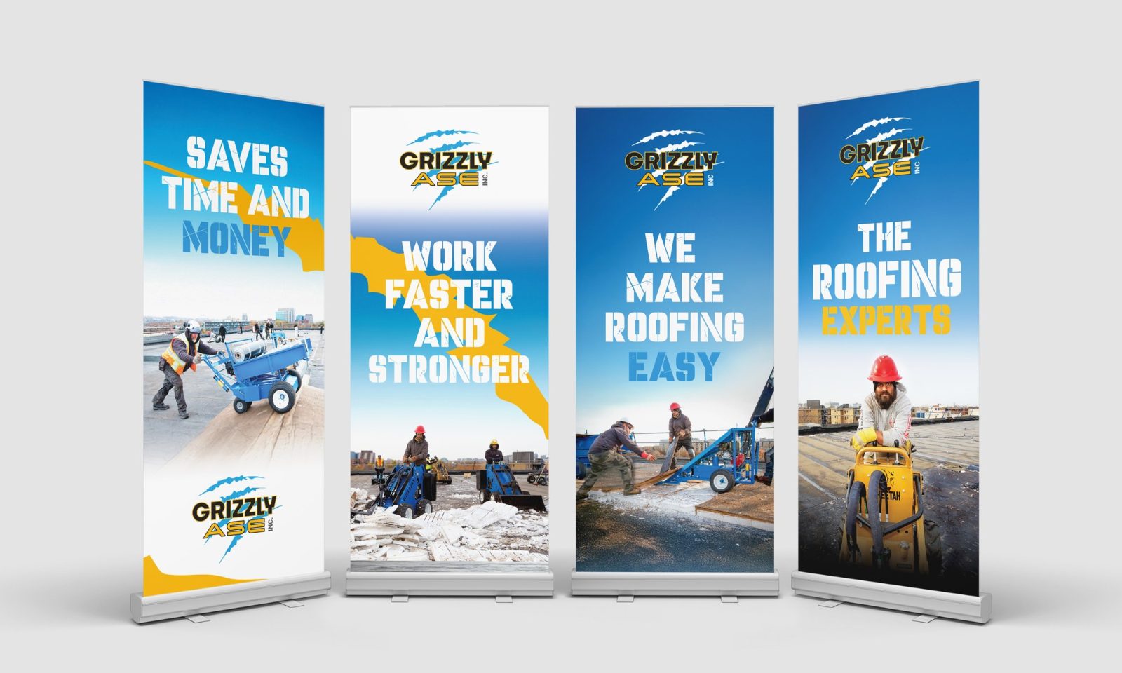 Four blue and yellow roll-up banners for Grizzly roofing equipment, headed Saves time and money, Work faster and stronger, We make roofing easy and The roofing experts, with photos of crews at work