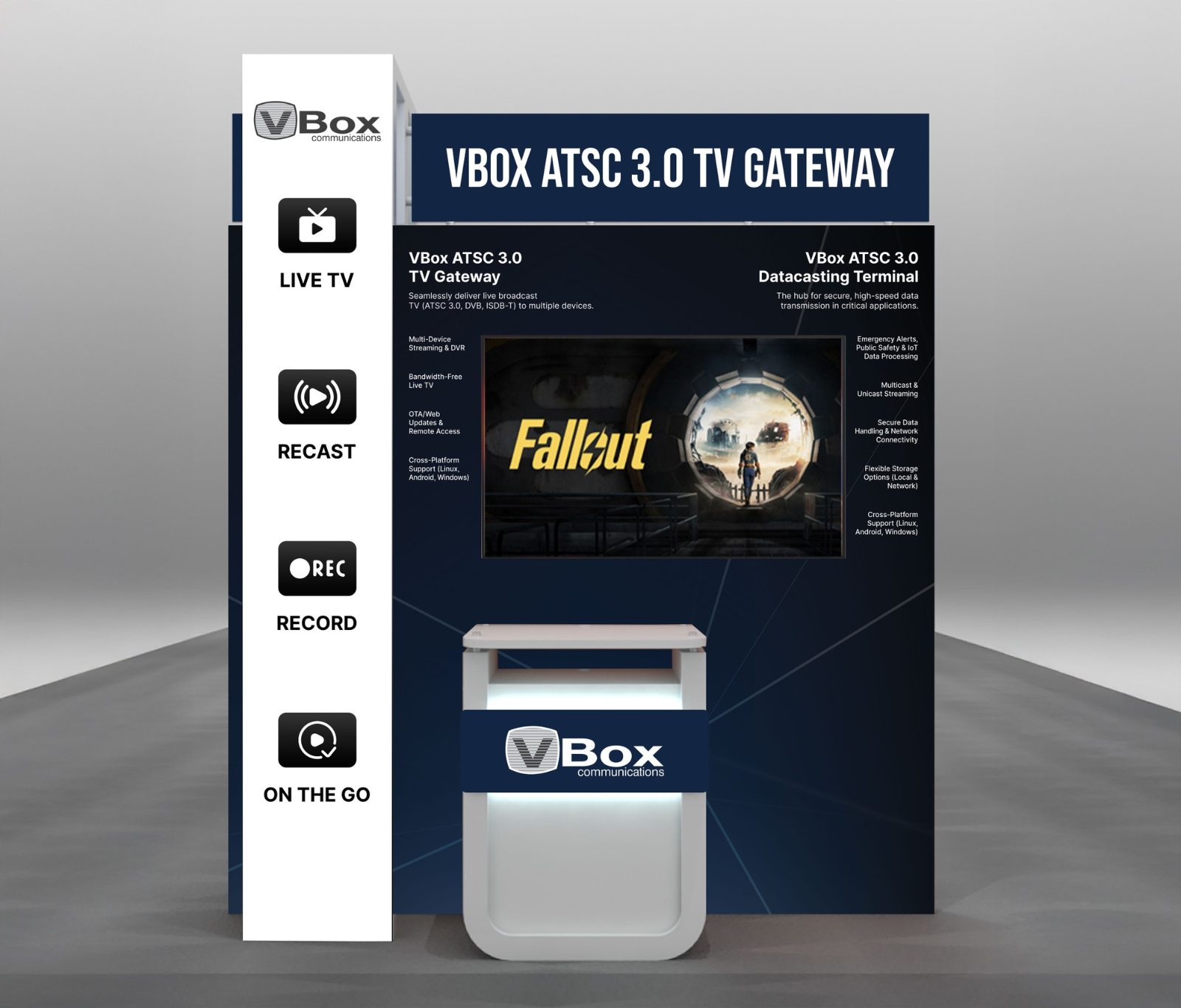 Dark blue booth for the VBox ATSC 3.0 TV Gateway with a screen on the back wall, a white tower of feature icons and a VBox counter